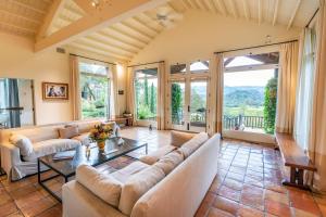 a living room with a couch and a table at Morlet Hilltop House in St. Helena