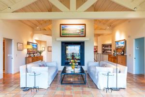 a living room with white couches and a table at Morlet Hilltop House in St. Helena +80 photos