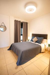 a bedroom with a large bed with blue pillows at Estrella del Sur in Torremolinos