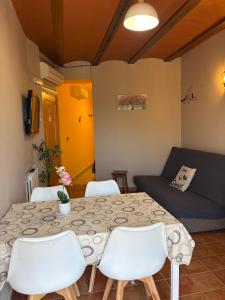 a room with a table and chairs and a couch at CASA JESUS in Abiego