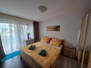 a bedroom with a bed with two stuffed animals on it at Ruhiges Nest in Bad Endorf