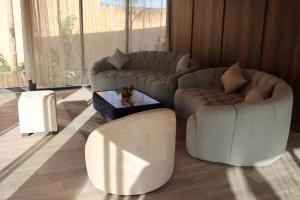 a living room with a couch and a table at Villa aya in Oujda