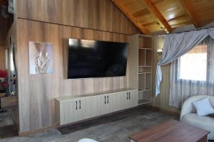 a living room with a flat screen tv on a wall at Villa aya in Oujda
