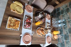 a table topped with different types of food and drinks at Villa aya in Oujda