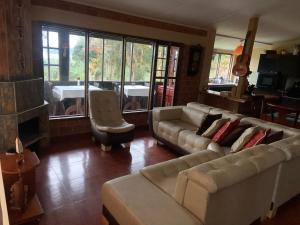 a living room with two couches and a table at Villa Marina in Pasto