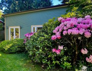 a house with pink flowers in front of it at The Family Cottage in Delta