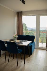 a living room with a table and a blue couch at Sunrise Yablunytsia in Yablunytsya +17 photos