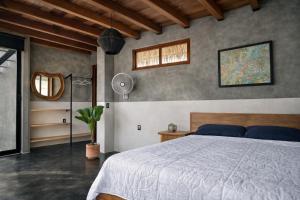 a bedroom with a large bed and a window at Casa Moorea - Steps to Beach in Puerto Escondido +40 photos