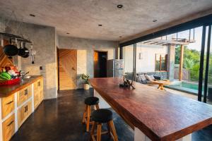 a kitchen with a large wooden counter in a room at Casa Moorea - Steps to Beach in Puerto Escondido