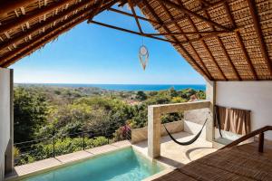 a villa with a plunge pool and a view of the ocean at Casa Moorea - Steps to Beach in Puerto Escondido