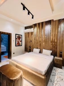 a bedroom with a large bed and a table at 3BED flat close to the airport lagos in Lagos