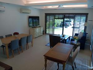 a living room with a table and a dining room at Villa La Origin Life in Phuket