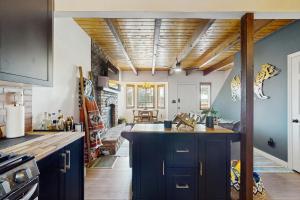 a kitchen with a large island in the middle at Boat, Hike, Fish! Summer Cabin Near Lake Arrowhead in Running Springs
