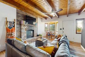 a living room with a couch and a fireplace at Boat, Hike, Fish! Summer Cabin Near Lake Arrowhead in Running Springs