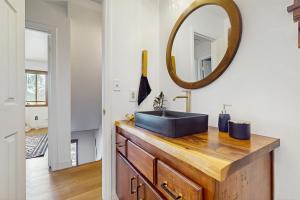 a bathroom with a black sink and a mirror at Boat, Hike, Fish! Summer Cabin Near Lake Arrowhead in Running Springs +16 photos