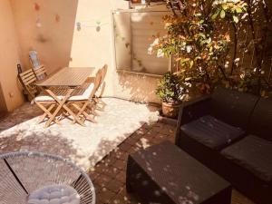 a patio with a table and a couch and chairs at Le Val Claret in Antibes +2 photos