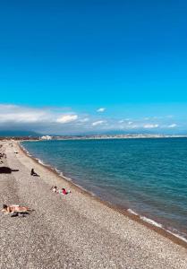 a group of people laying on the beach at Le Val Claret in Antibes