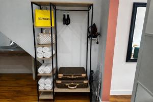 a walk in closet with a shelf with luggage at Stylish 1-Bed Apartment in Chester with Parking & Full Kitchen in Chester