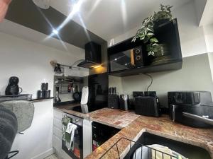 a kitchen with a counter top with a sink at Stylish 1-Bed Apartment in Chester with Parking & Full Kitchen in Chester +10 photos
