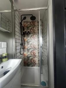 a shower with a glass door in a bathroom at Stylish 1-Bed Apartment in Chester with Parking & Full Kitchen in Chester