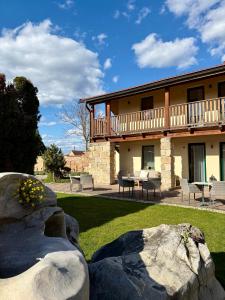 a large building with a table and chairs in a yard at Hotel Garni Klaret in Valtice
