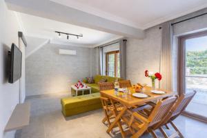 a dining room and living room with a table and chairs at Villa Aysel Paradise in Dalyan
