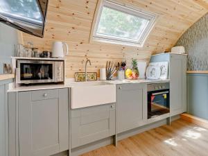 a kitchen with white appliances in a tiny house at 1 Bed in Okehampton oc-92384 in Okehampton +10 photos