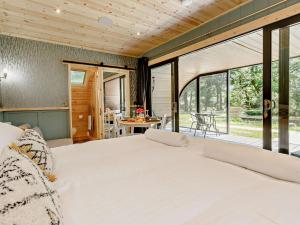 a bedroom with a large bed and a patio at 1 Bed in Okehampton oc-92384 in Okehampton