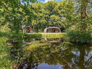 two domes on the shore of a lake with trees at 1 Bed in Okehampton oc-92384 in Okehampton