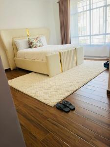 a living room with a couch and a rug at Eunas homestay in Eldoret