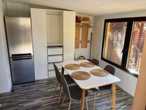 a kitchen with a table and chairs and a refrigerator at Bambusz76 in Zamárdi +11 photos