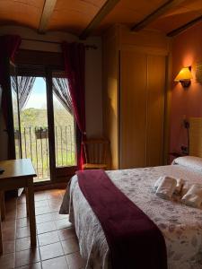 a bedroom with a bed and a large window at CASA JESUS in Abiego