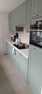 a kitchen with white cabinets and a white counter top at Wervik-94 in Wervik