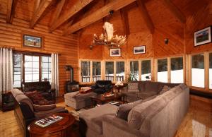 a living room with couches and chairs in a cabin at Tuckamore Lodge in Main Brook