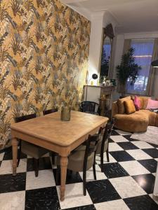 a dining room with a table and a couch at Wervik-94 in Wervik