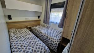 a small room with two beds and a window at Les Prairies de la Mer - Baie de Somme in Favières