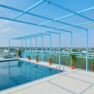 a swimming pool on the roof of a building at Hotel Crown Park Ltd in Sylhet