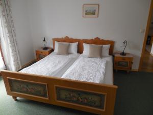 a bedroom with two beds and two night stands at Schmidhauser Hof in Unterwössen