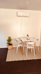 a white table and chairs in a room at Casa Tetis in La Floresta