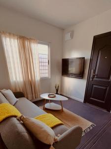 a living room with a couch and a table at Casa Tetis in La Floresta