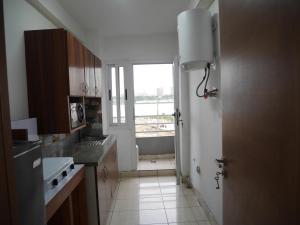 a kitchen with a sink and a tub and a window at LA MAISON SEONE f4 FAMILLE in Abidjan +6 photos