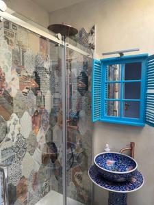 a bathroom with a sink and a glass shower at Villa Dorée in Milan +43 photos