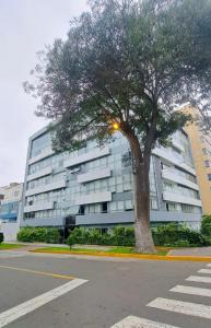 a large building with a tree in front of it at Luxloft in Lima