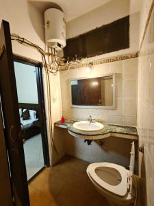 a bathroom with a toilet and a sink at Hotel jewel in Haridwār
