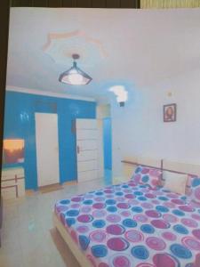 a bedroom with a large bed in a room at Appartement bonita in Dakar