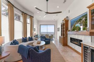 a living room with a couch and a fireplace at Sea-Esta - 1136 Postell in East End +26 photos