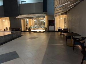 a restaurant with tables and chairs in a lobby at Morden luxury studio in Jaipur