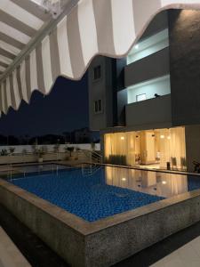 a swimming pool in the middle of a building at night at Morden luxury studio in Jaipur