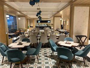 a restaurant with tables and chairs in a room at Morden luxury studio in Jaipur