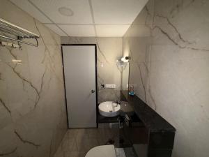 a bathroom with a white toilet and a sink at Morden luxury studio in Jaipur +5 photos